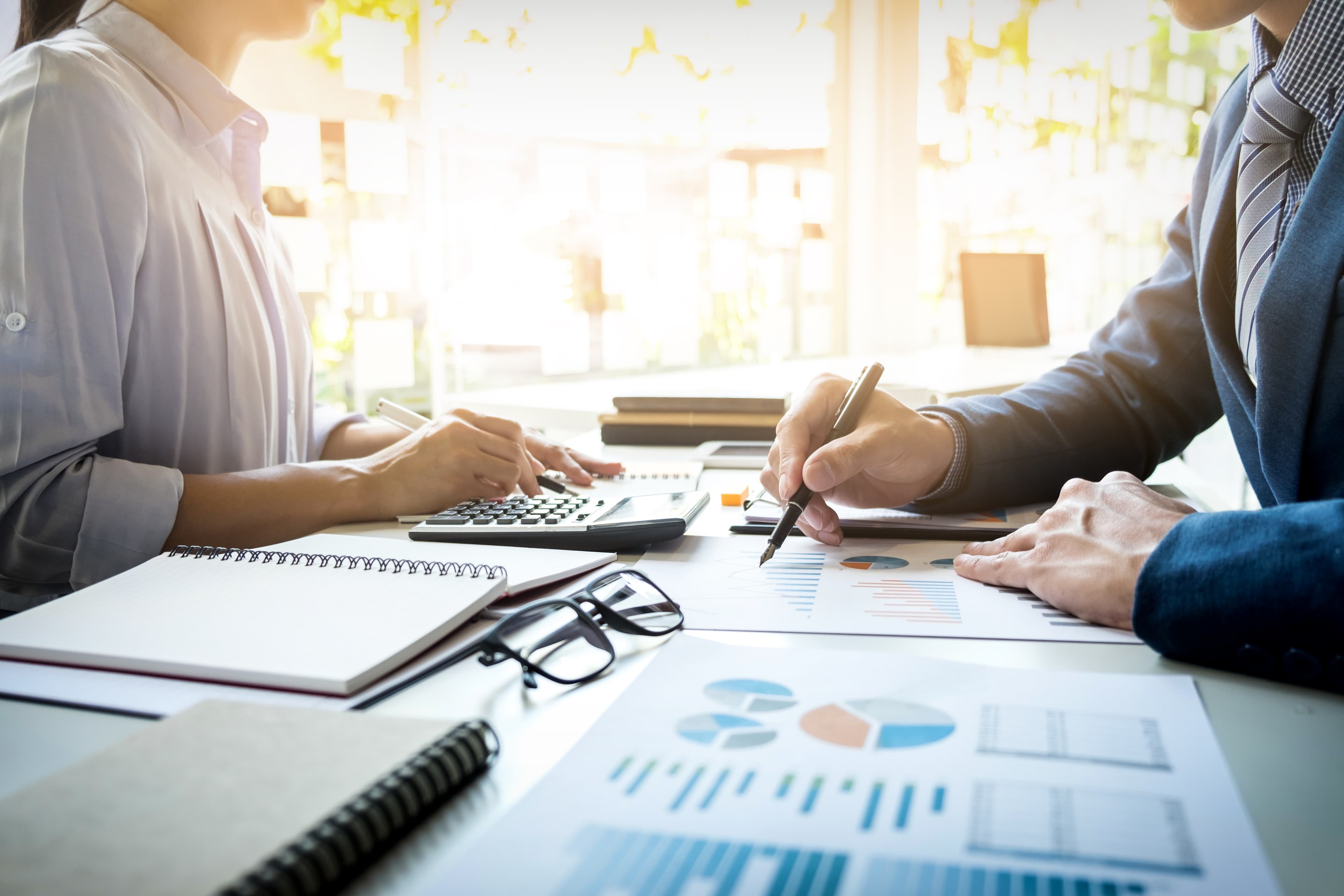 Finance professionals reviewing business reports